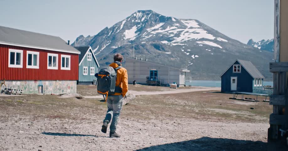 Man walking amidst colorful houses in a village
