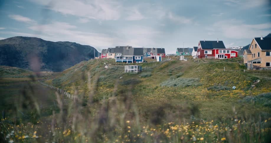Colorful houses on the hills next to the mountains