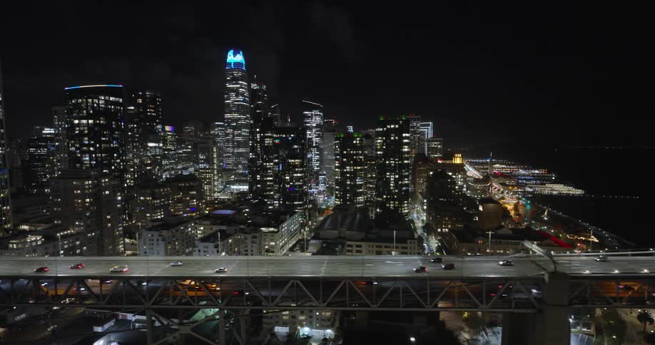Traffic runs on the bridge by the city at night