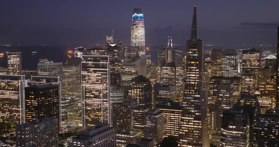 Lights on metropolitan buildings and towers glow in the darkness