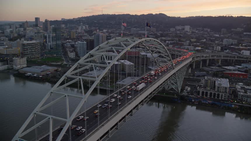 Traffic runs over the bridge into the city