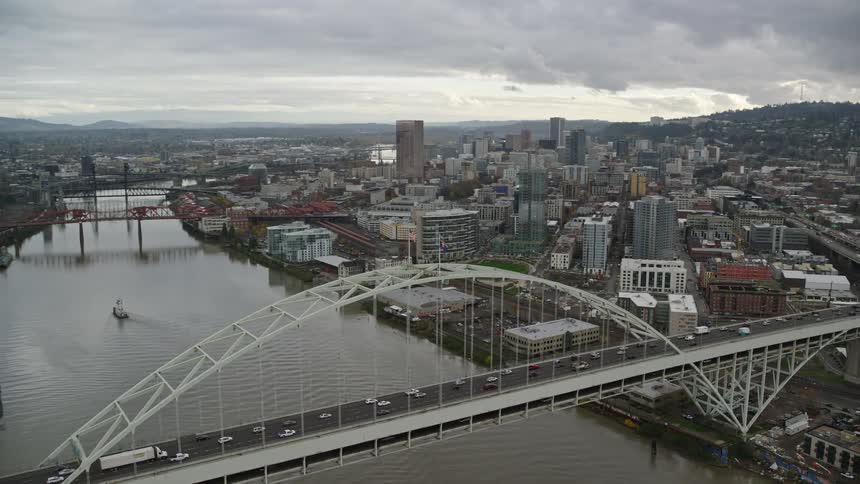 Aerial view of bridges over a river on a waterfront city at evening