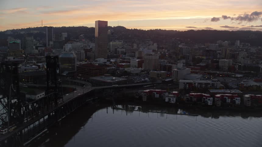 A river that passes through an urban region of a city on a dark morning