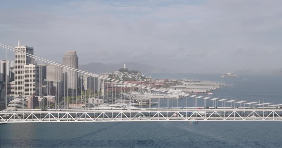 Cars are driving on a bridge over a body of water