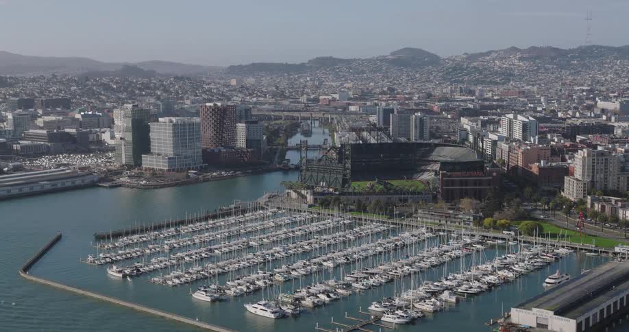 Aerial view of a marina next to a waterfront city