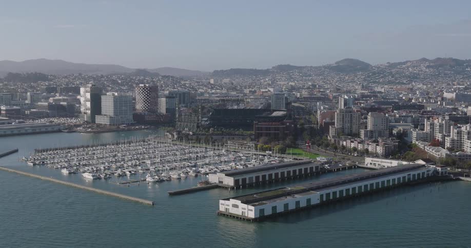 Aerial view of a large marina next to a waterfront city