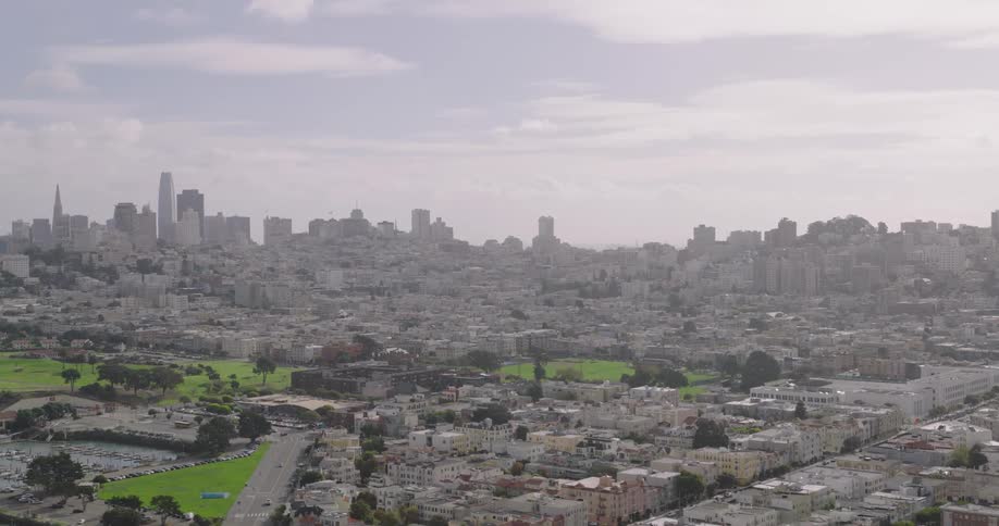 Homes lie before the tall buildings
