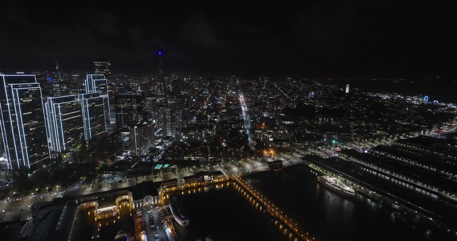 Aerial view of night lights in a waterfront city