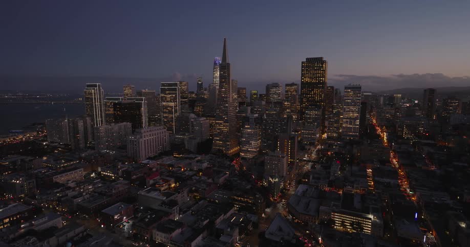 The center of a metropolitan city at night with several tall buildings