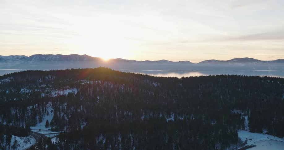 Aerial view of a lake in the mountains at sunset
