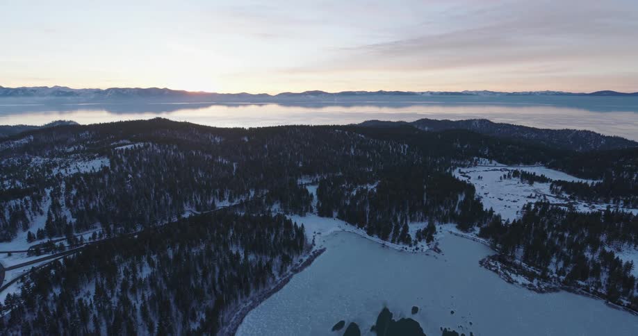 Aerial view of a lake in the mountains at sunset