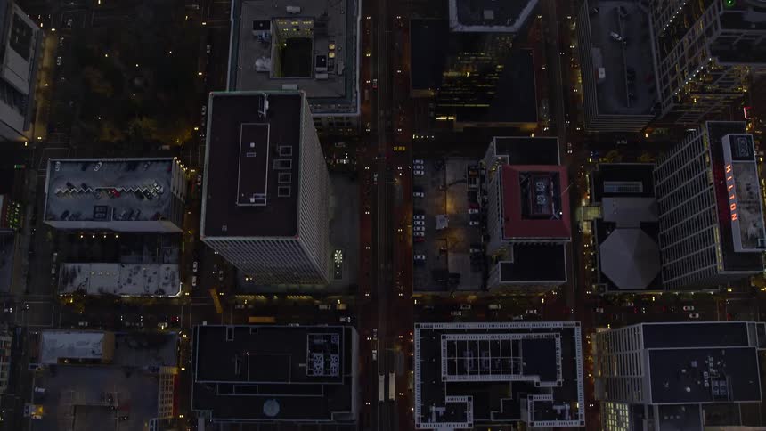 An aerial birds eye view of the downtown area of a busy metropolis at night