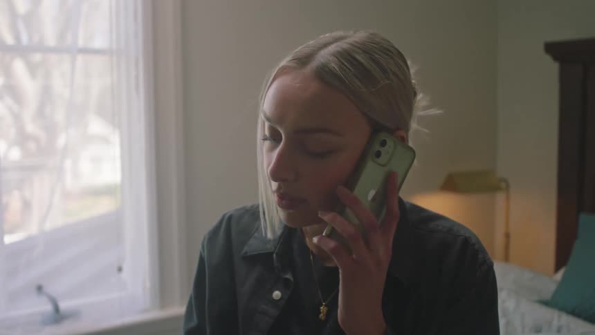 Woman answers a call in the bedroom