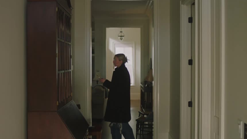 Woman picks up her coat and walkman before leaving home