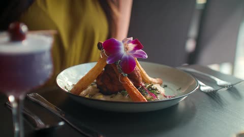 A meal decorated with a flower in a restaurant