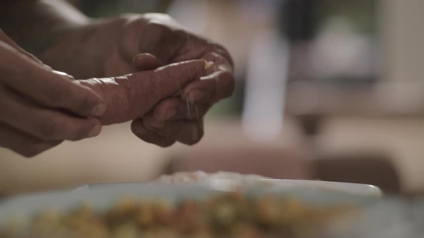 Two people are preparing food