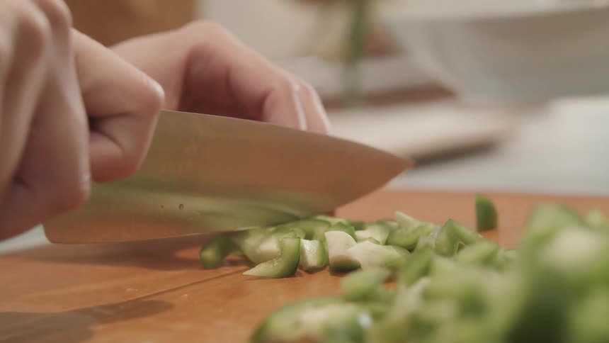 People chopping vegetables at home with a sharp kitchen knife