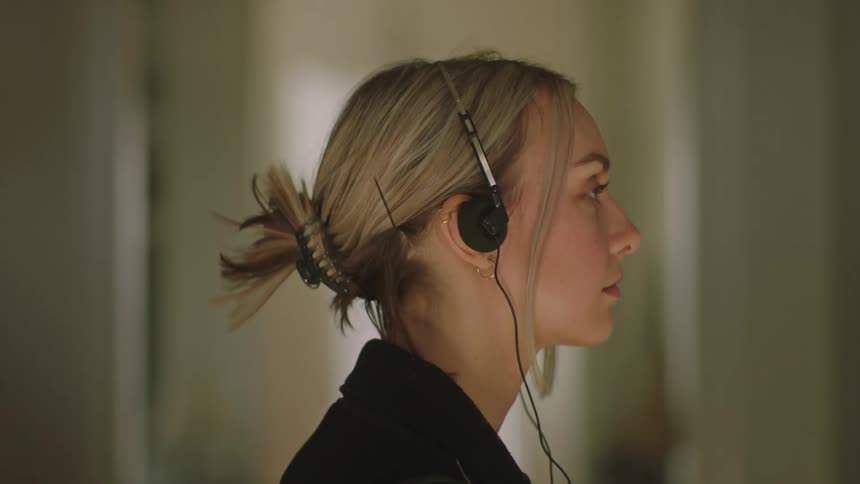 A close up clip of a female putting on her headset