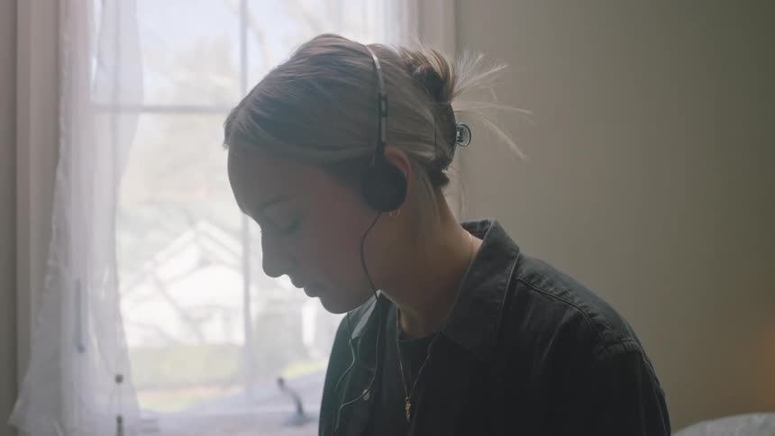 Woman listening to cassette tapes in the bedroom