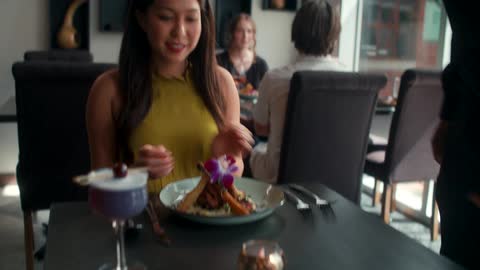 A woman is happy when her food is served
