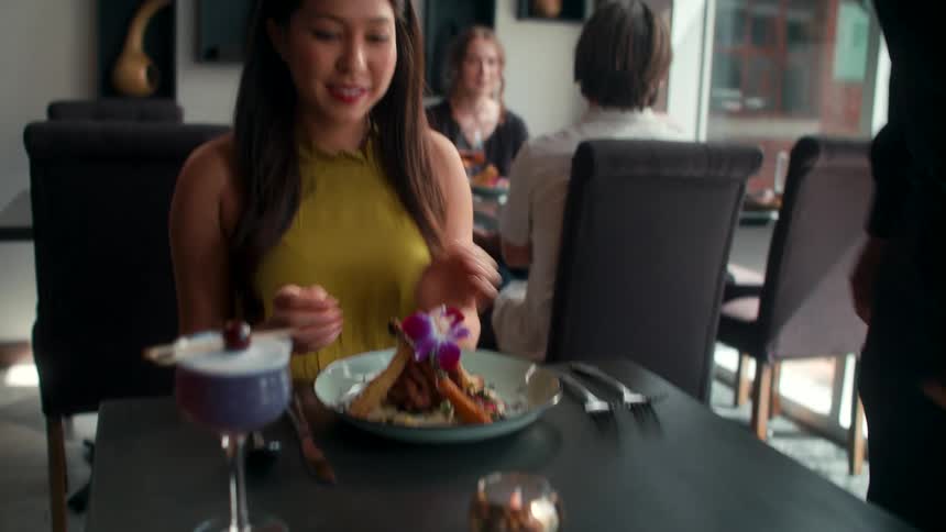 A woman is happy when her food is served