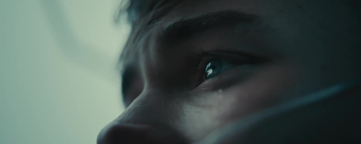 A face of a man whose eyes are crying and making tears