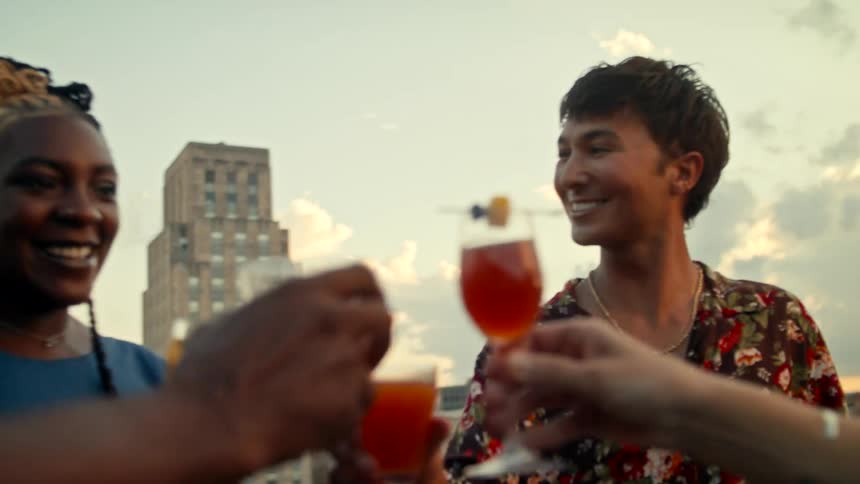 Friends toast with cocktails on a party in the city