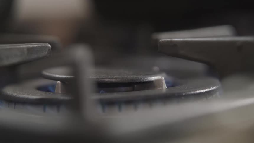 A stove burner lighting a fire