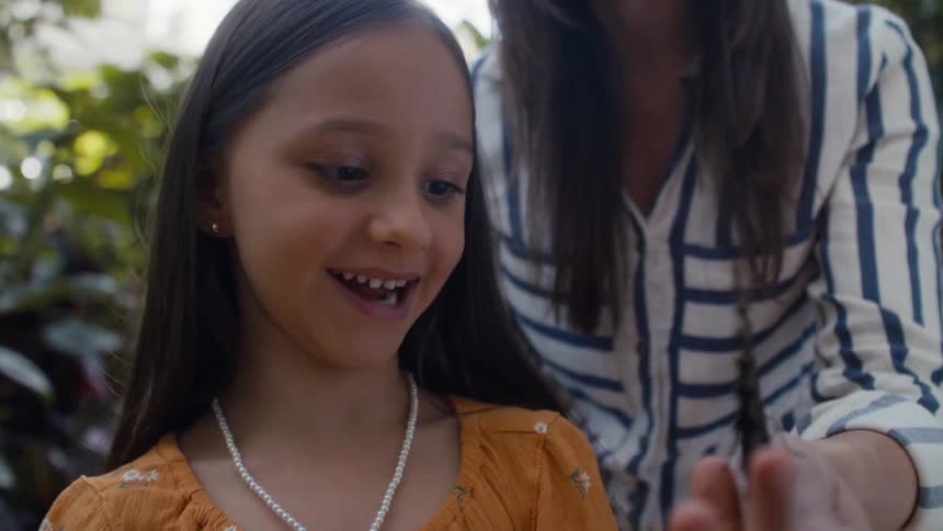 Happy girl playing with a butterfly