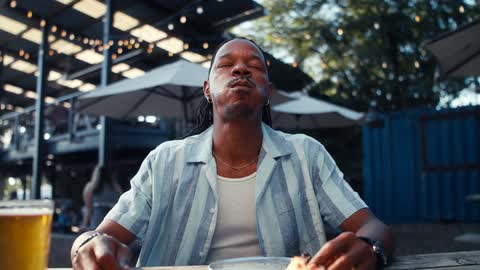Satisfied man eating pizza in a restaurant