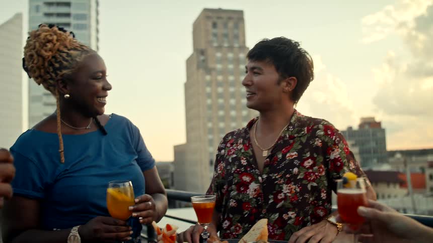 Friends drinking and talking on the terrace of a building