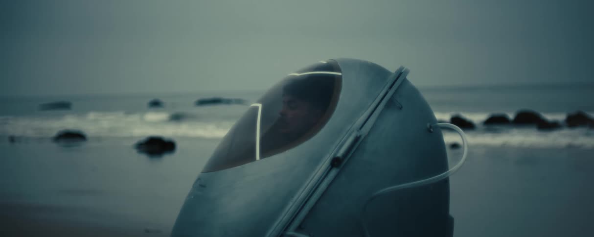 A large round shaped capsule on a beach