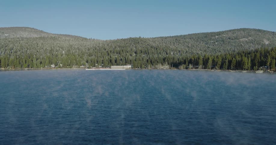 Aerial view of light fog over a lake in the mountains