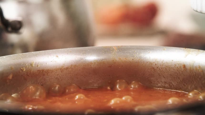 A pot of boiling tomato sauce