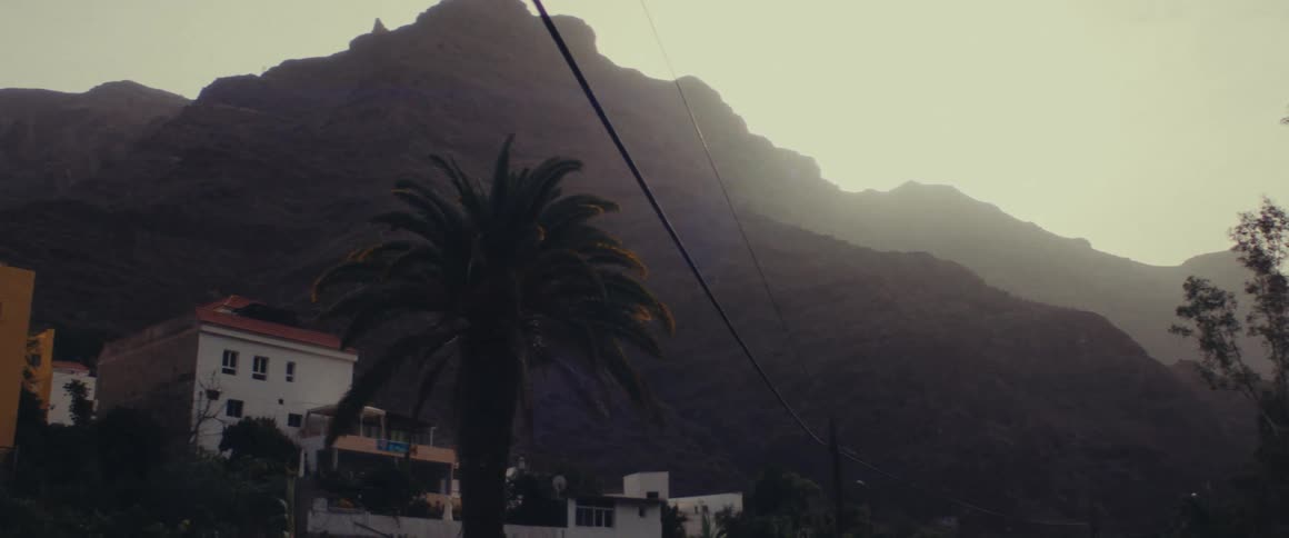 Houses amidst the mountains under a morning sky