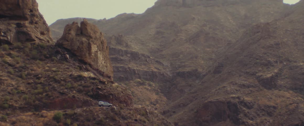 A parked vehicle on a hill at daytime