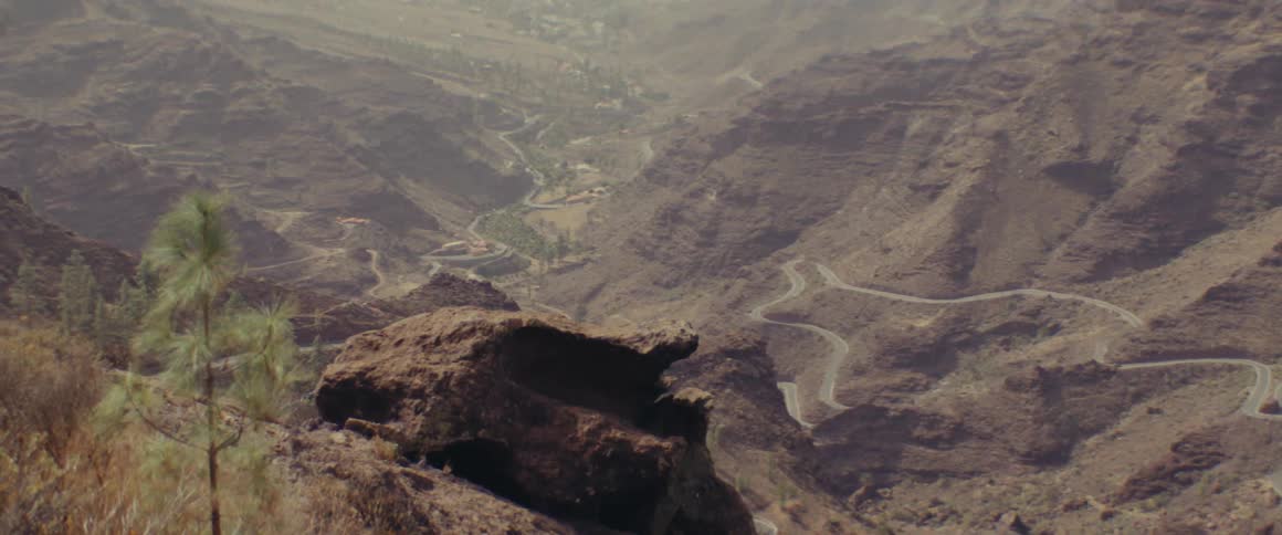 A long dangerous road in the mountains during a cloudy day