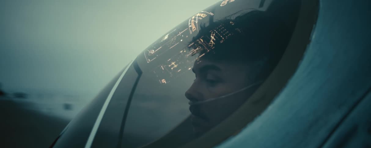 A man inside a pod giving him readings on the inside of the glass