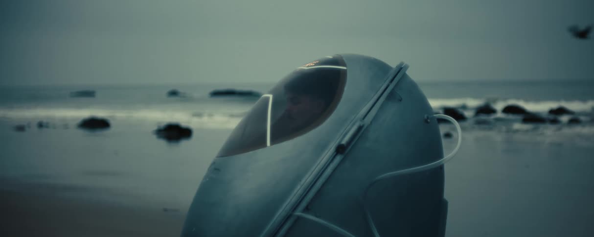 A capsule pod is on the beach