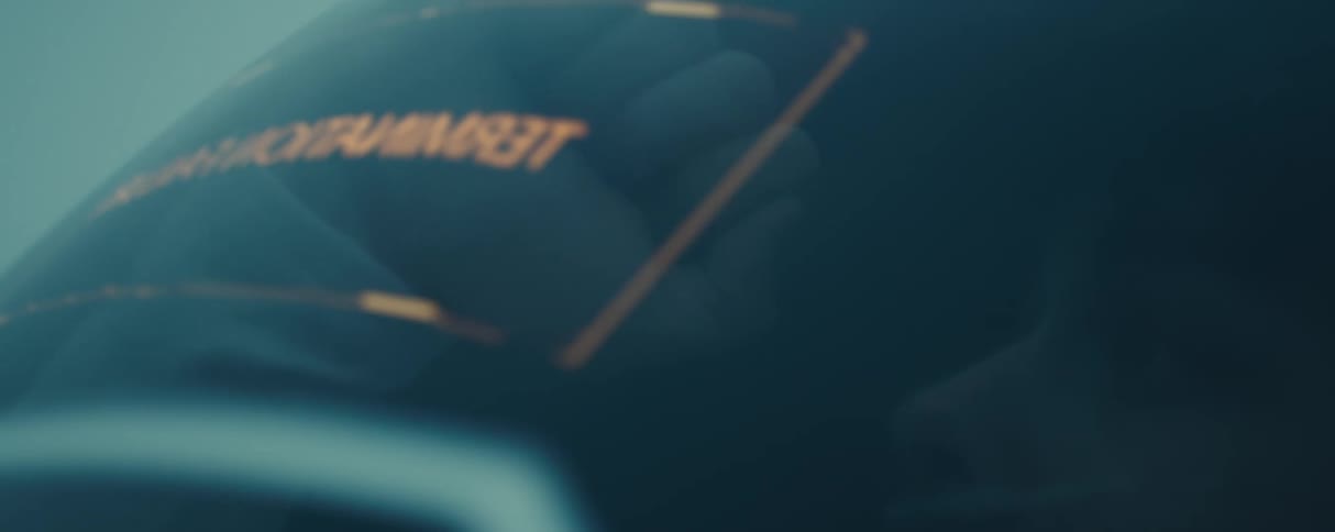 Closeup of a man throwing a punch while confined inside a capsule