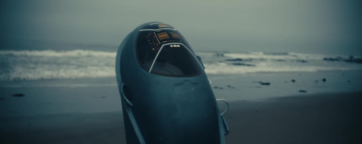 A pod with a display on the front is on the beach