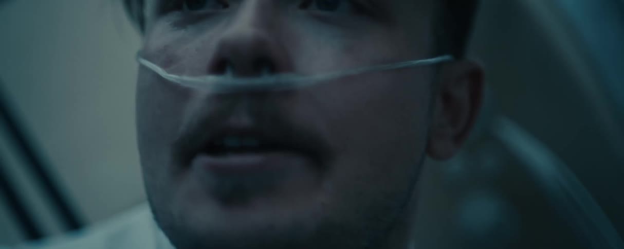 A very angry and agitated man screaming while wearing a breathing aid