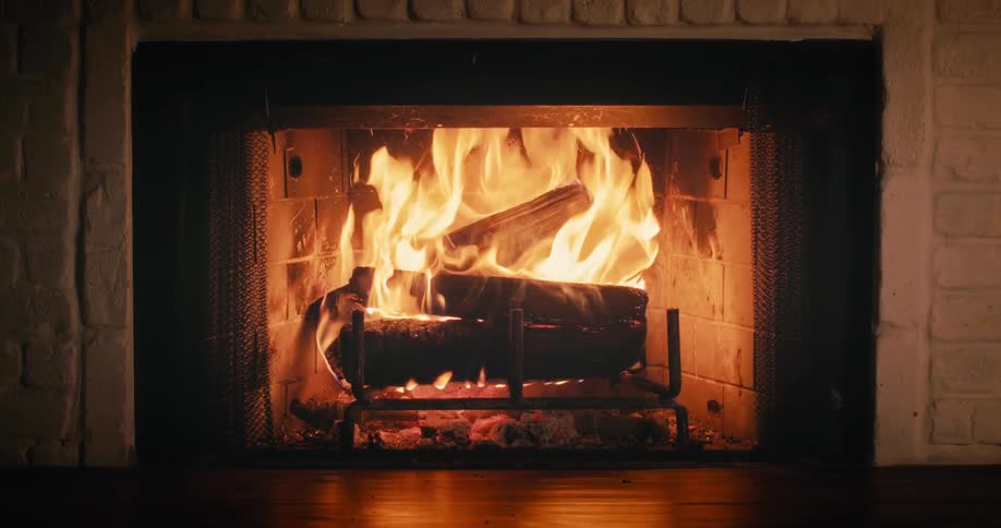 Roaring fire burns in fireplace of home