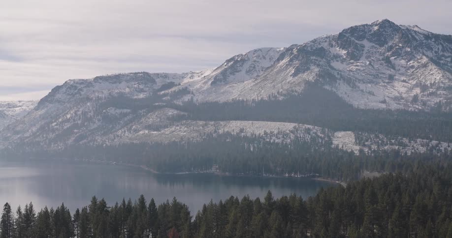 Aerial view of snow capped mountains and a serene lake