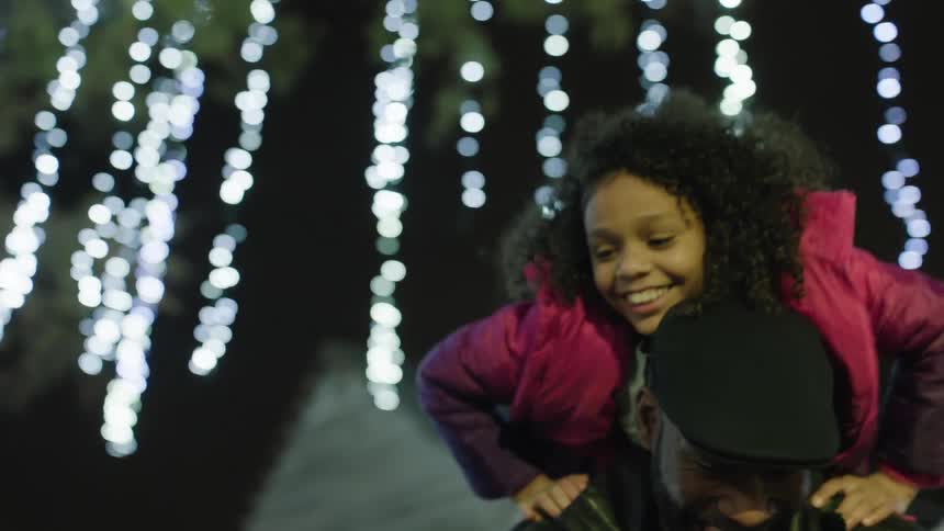 Family having fun under the christmas lights