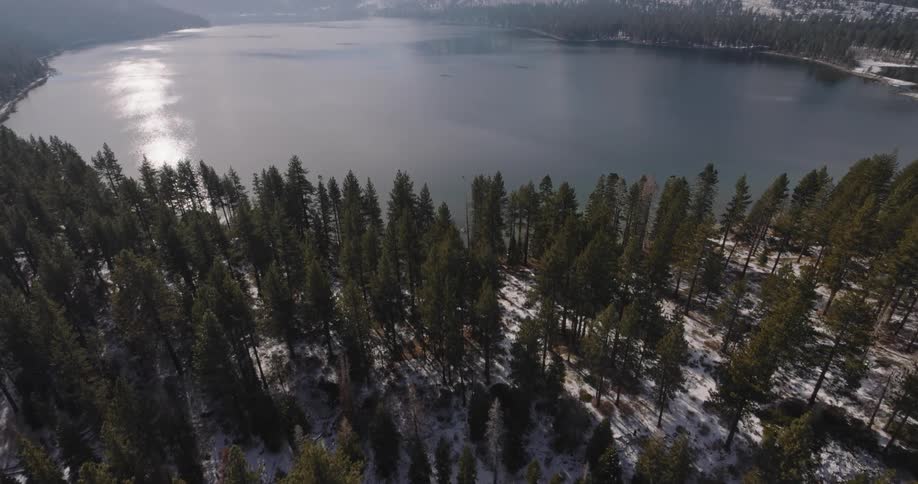 A mountain range and forest surround the lake
