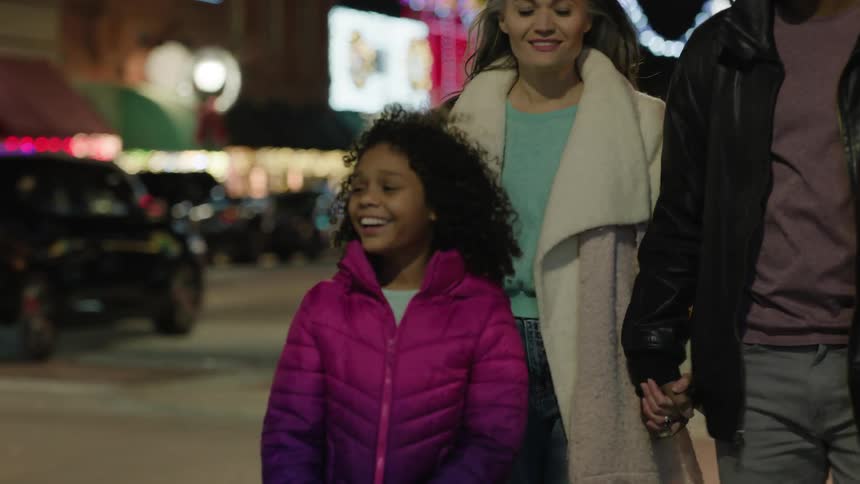 Family walk on the city streets at christmas