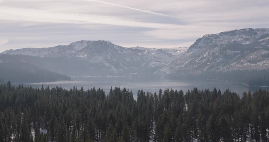 Aerial view snow covered mountain forest lake