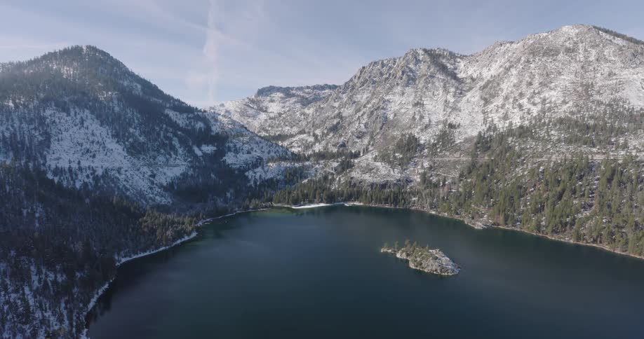 Aerial view of a lake surrounded by snowy mountains