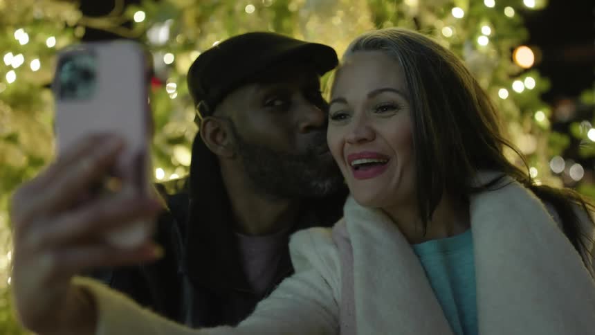 Happy couple take a selfie at christmas